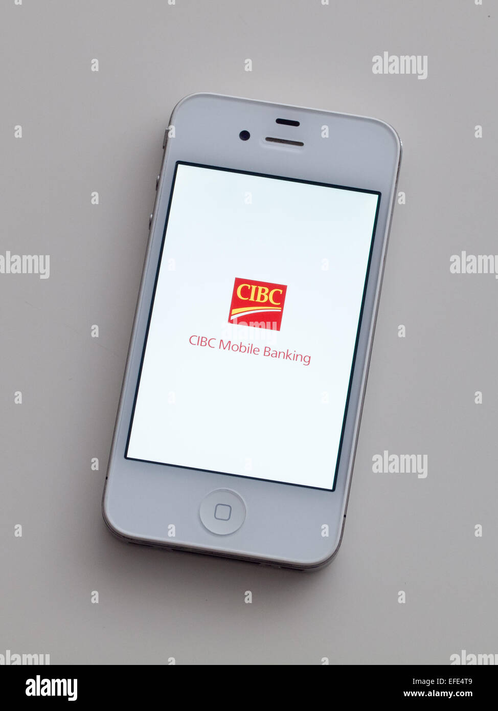 A view of the logo and homescreen of the Canadian Imperial Bank of Commerce (CIBC) mobile banking app on an Apple iPhone 4. Stock Photo