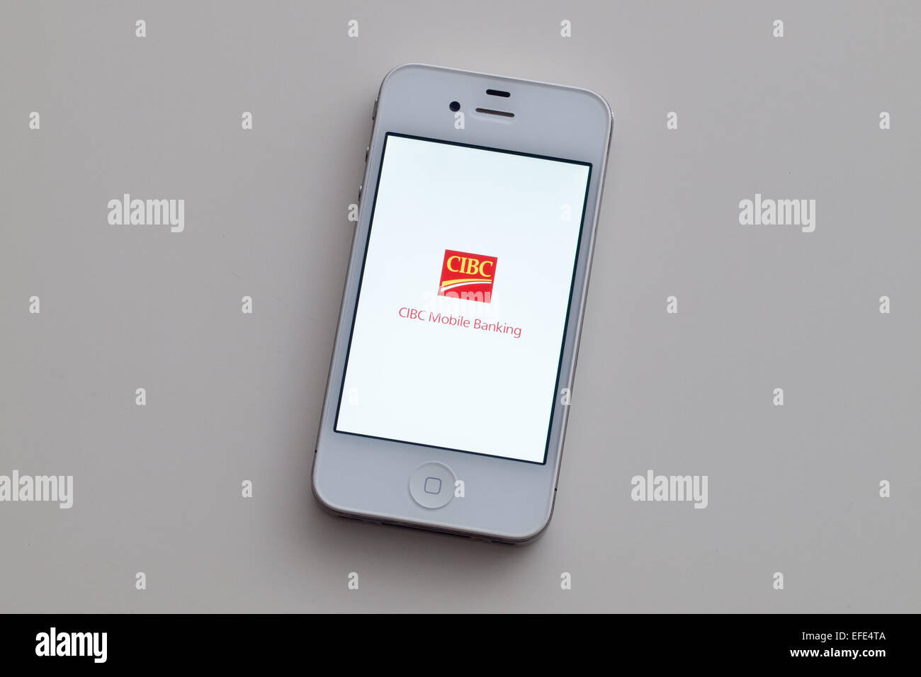 A view of the logo and homescreen of the Canadian Imperial Bank of Commerce (CIBC) mobile banking app on an Apple iPhone 4. Stock Photo