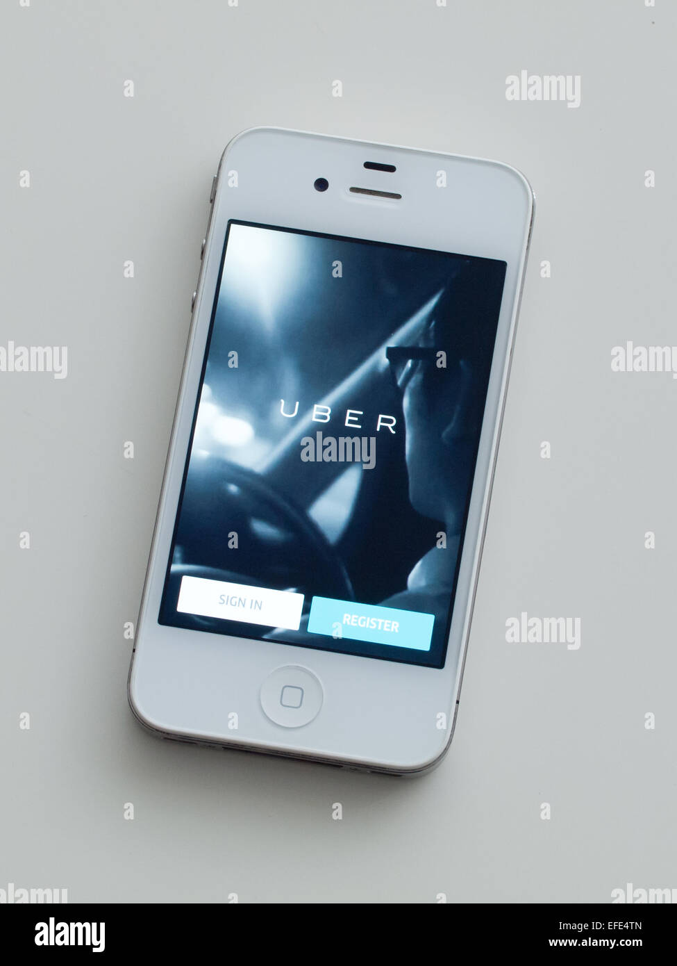A view of the homescreen of the Uber app on a white, Apple iPhone 4. Stock Photo