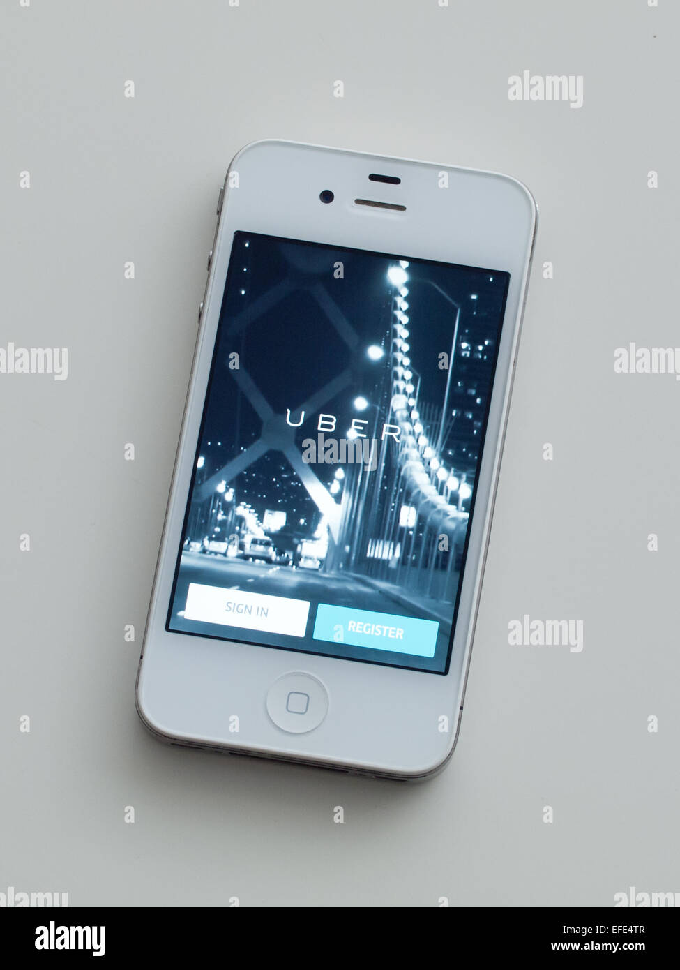 A view of the homescreen of the Uber app on a white, Apple iPhone 4. Stock Photo