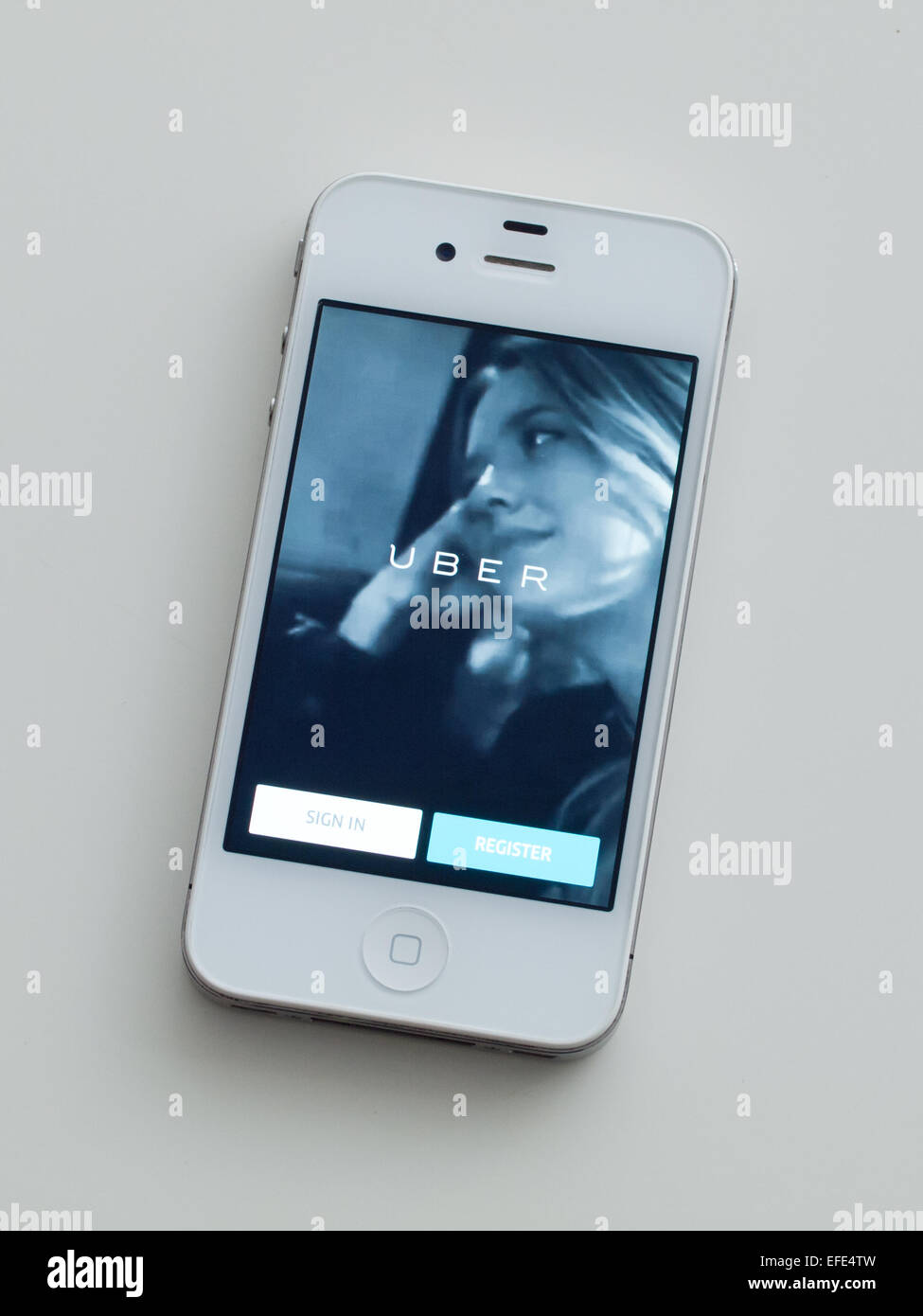A view of the homescreen of the Uber app on a white, Apple iPhone 4. Stock Photo