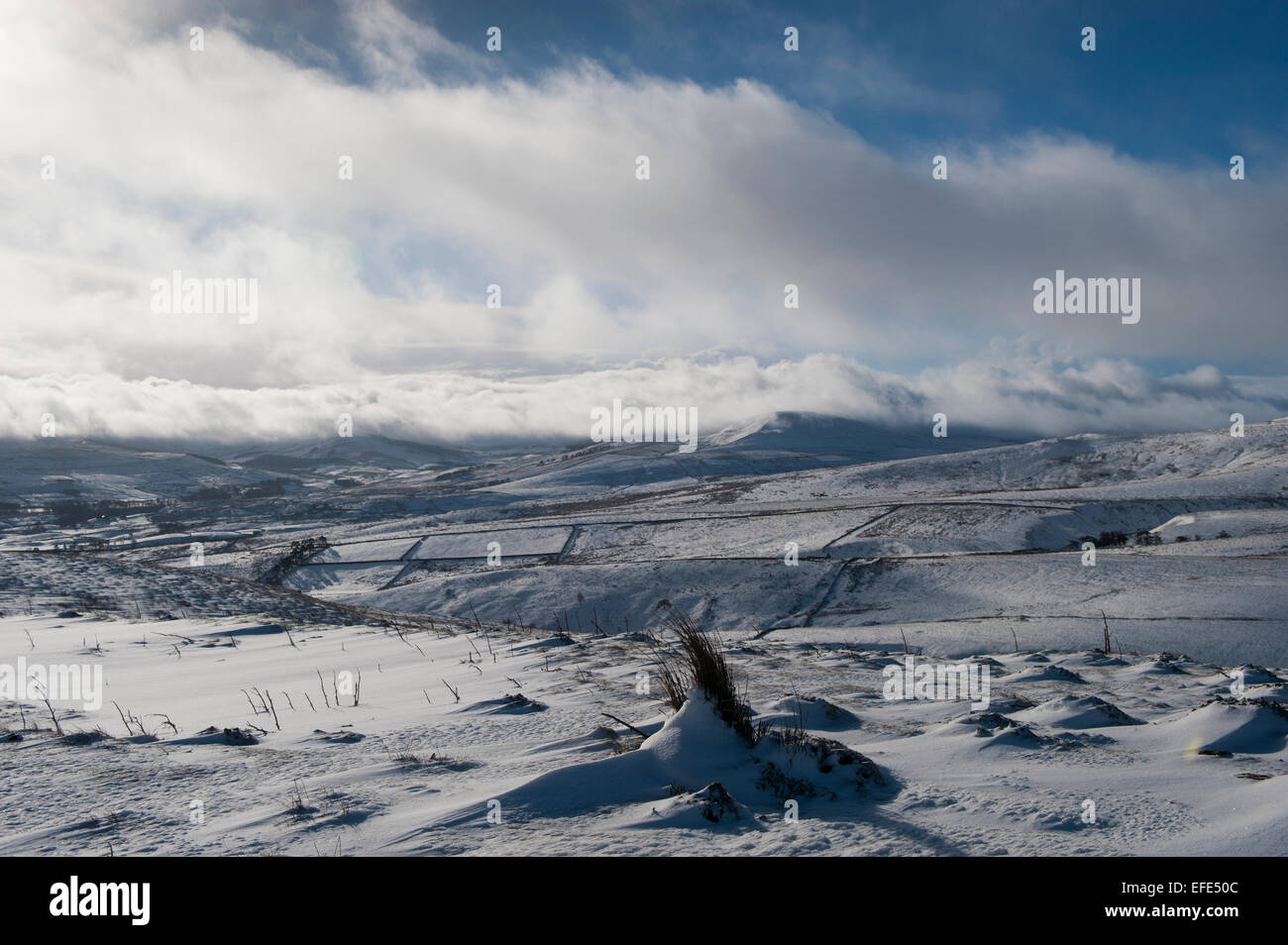 Clouds sweeping over upper Wensleydale hills following a snow storm, UK. Stock Photo