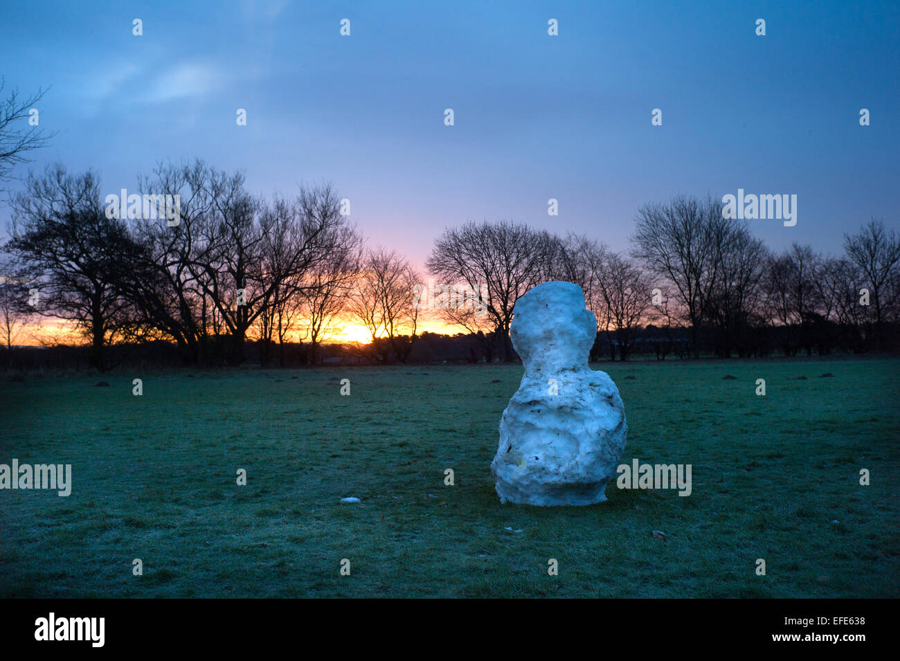 Knutsford, Cheshire, UK. 2nd February, 2015. UK Weather: As dawn breaks this morning this snowman on Rostherne Cricket Club, Knutsford is the  'Last man standing' as the weekend thawed out much of the snow. Temperatures though still remain freezing. Credit:  Howard Barlow/Alamy Live News Stock Photo