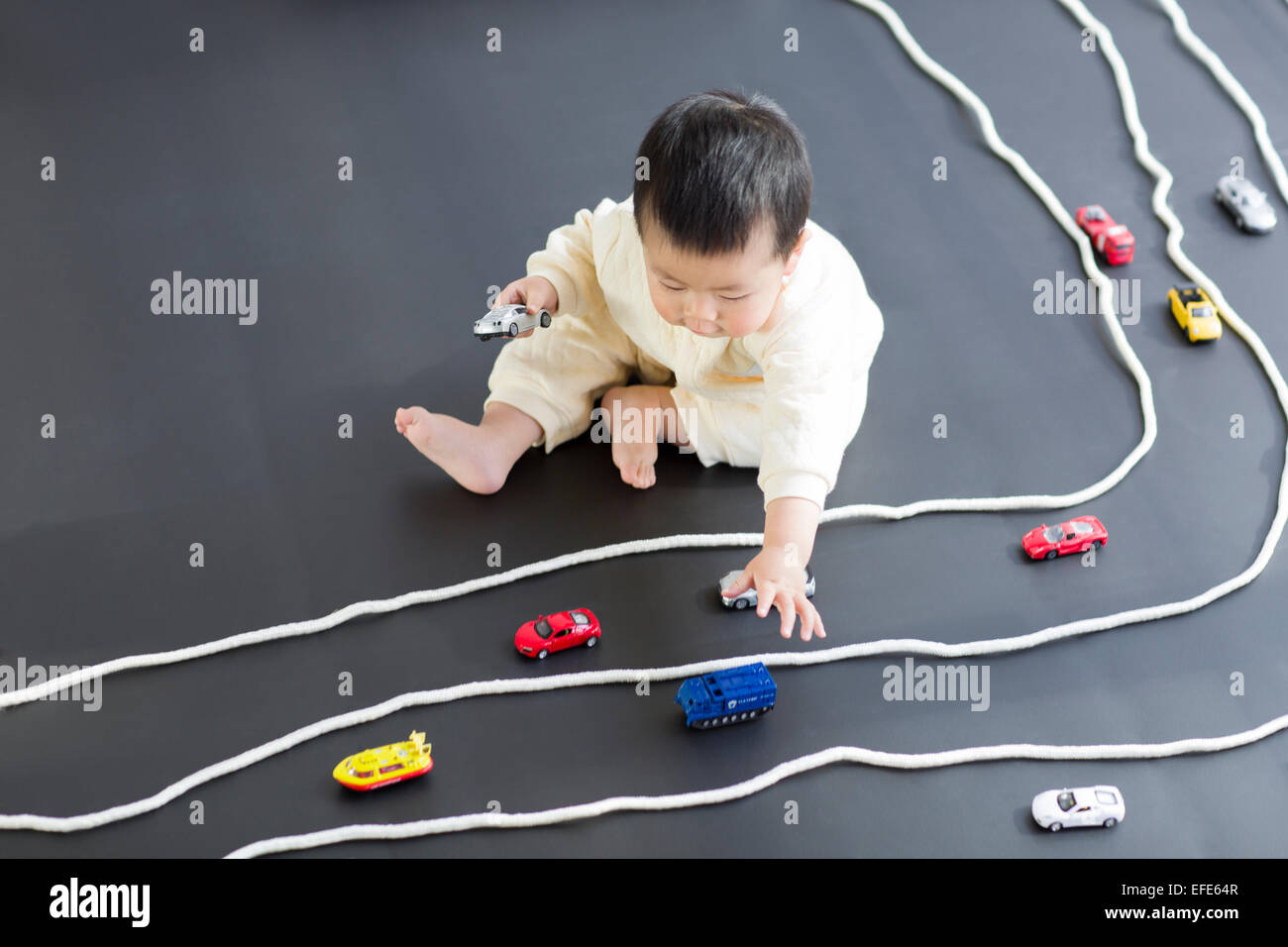 Cute baby playing with toy cars Stock Photo Alamy