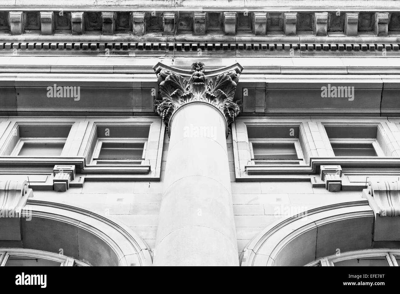 Looking up perspective of a pillar on a classic building in the UK