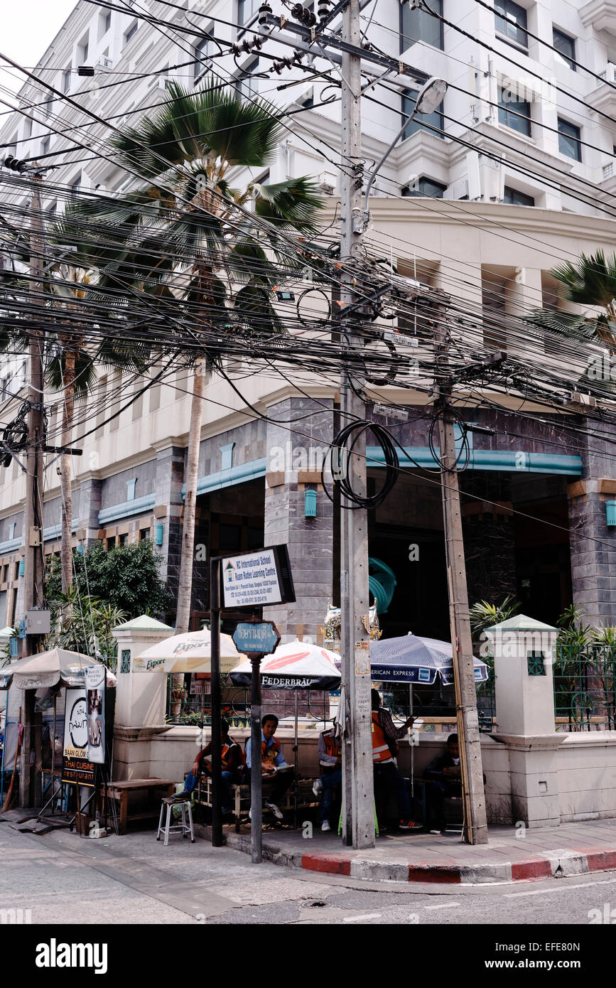 Power telecoms telephone telecommunication electricity cables hanging in Bangkok above the streets. Stock Photo