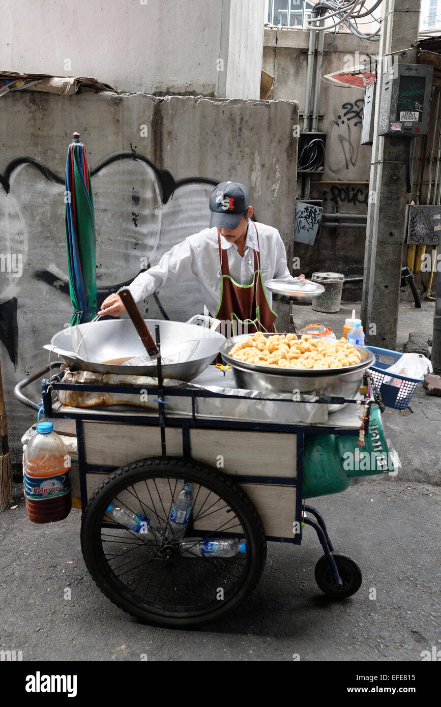 Hawker stall providing street food by the roadside in Bangkok providing
