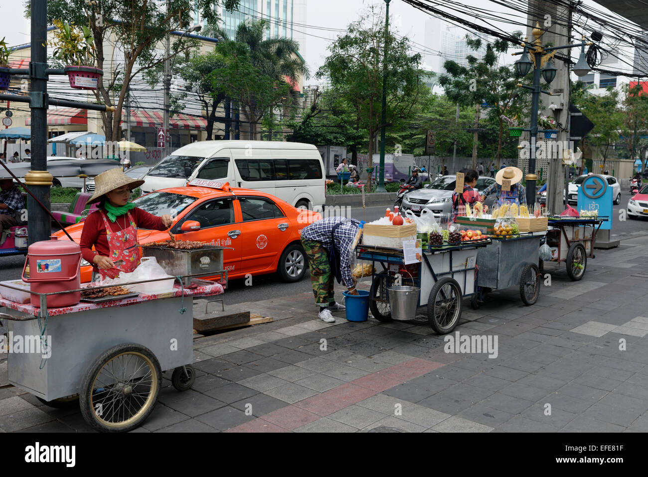 Hawker stalls providing street food by the roadside in Bangkok