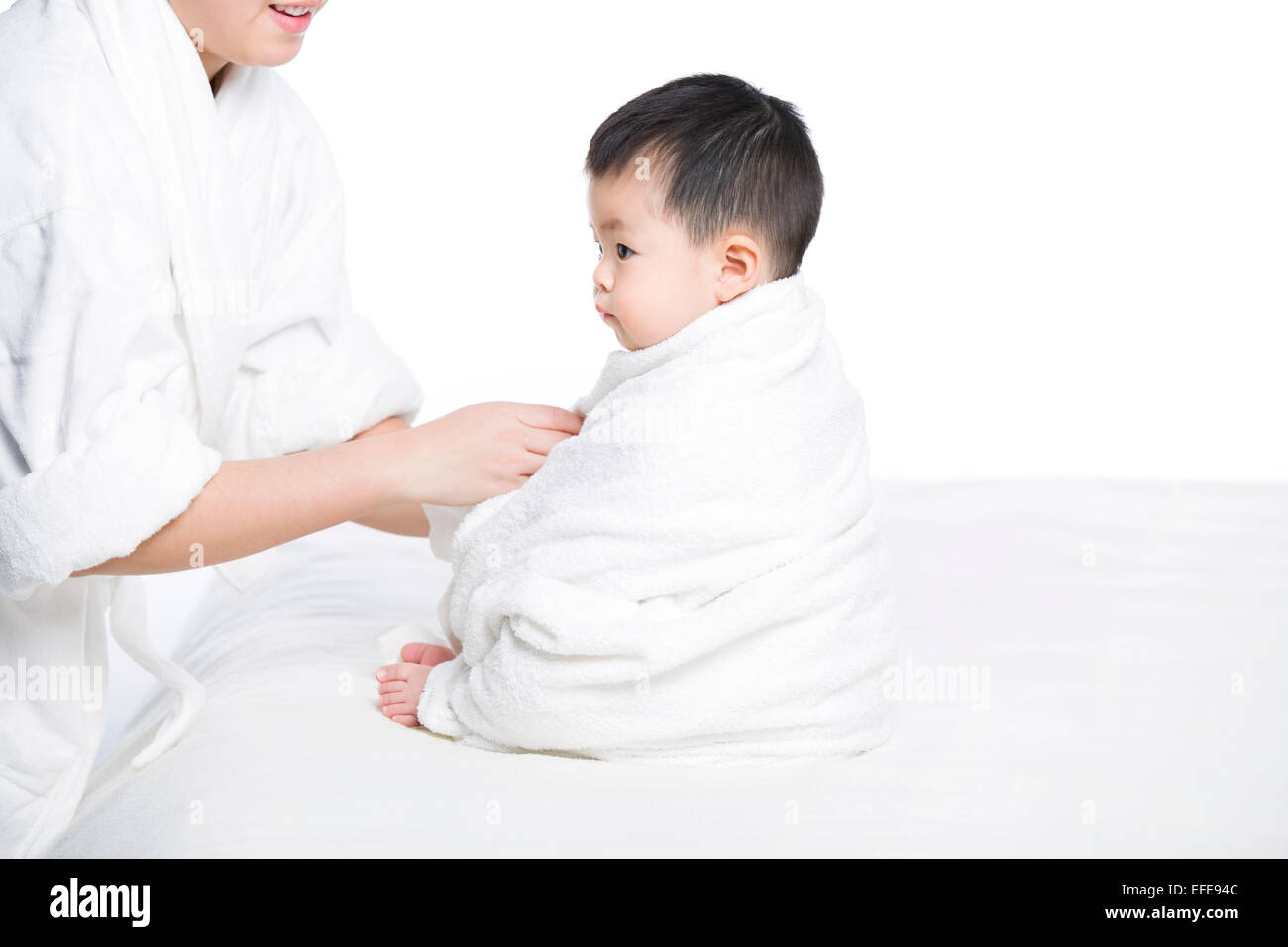 Mother wrapping baby in blanket Stock Photo Alamy