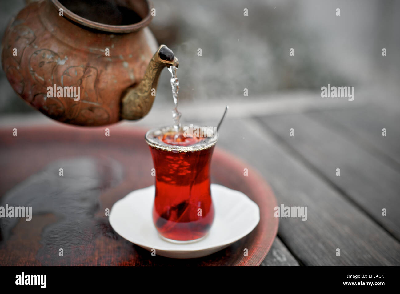 Turkish tea being poured in an outdoor cafe is pictured as part of a photo essay on winter breaks in Istanbul, Turkey. Stock Photo