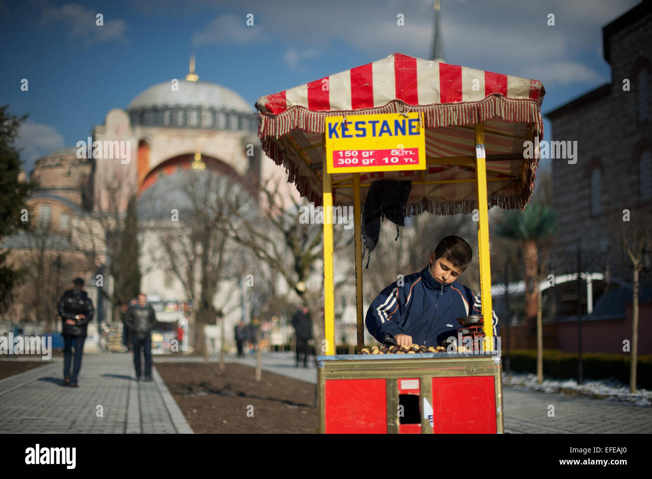 A young boy is pictured selling roast chestnuts as part of a photo essay on winter breaks in Istanbul, Turkey. Stock Photo
