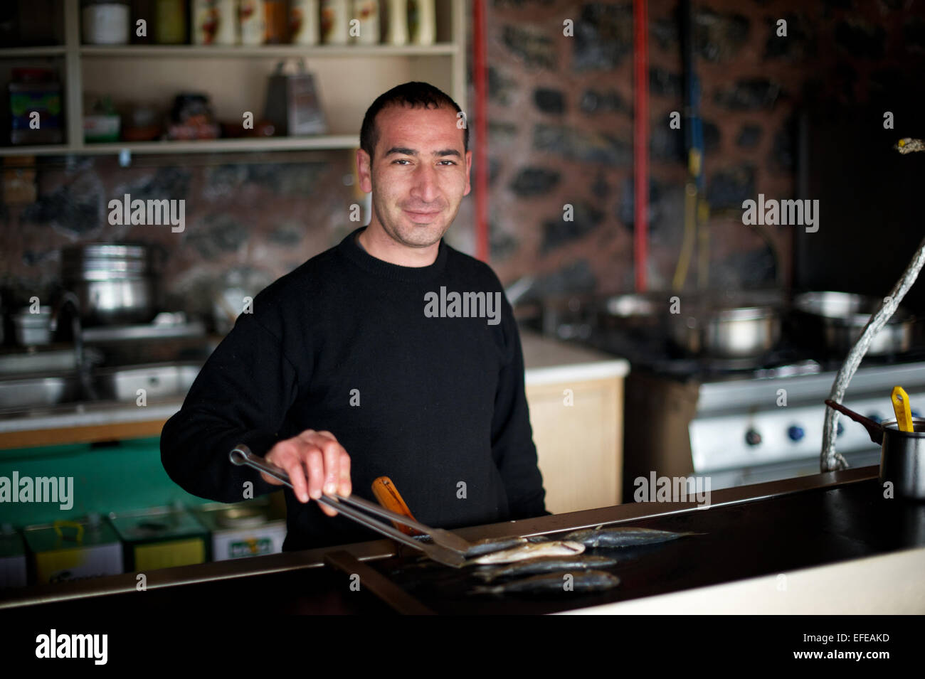 A local restaurant worker in Anadolu Kavagi is pictured as part of a photo essay on winter breaks in Istanbul, Turkey. Stock Photo