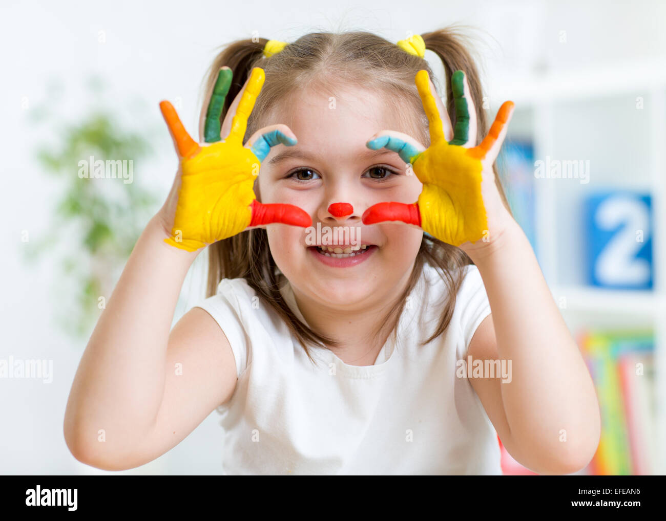 cute child have fun painting her hands Stock Photo