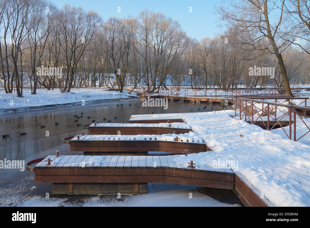 Empty boat station on the river in winter Stock Photo