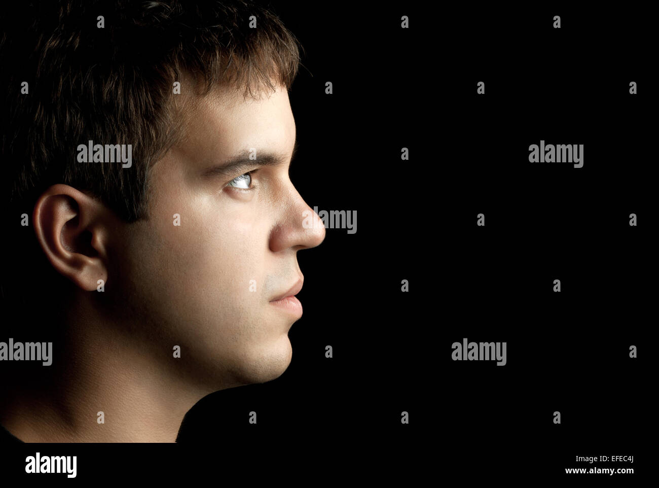 closeup portrait of young man isolated on black background Stock Photo ...