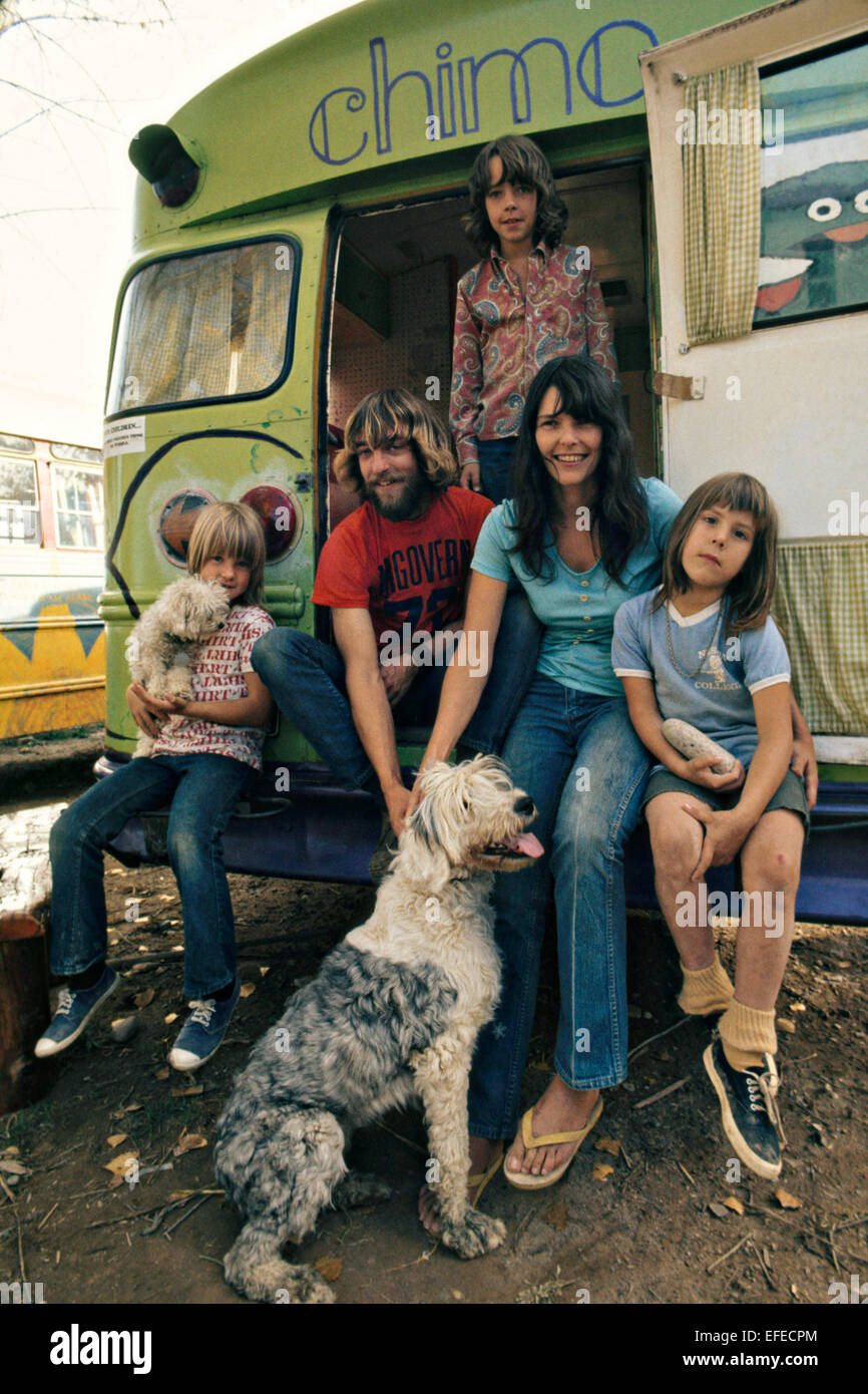 A hippy family poses by their painted school bus which they call home October 1972 in Rifle, Colorado Stock Photo