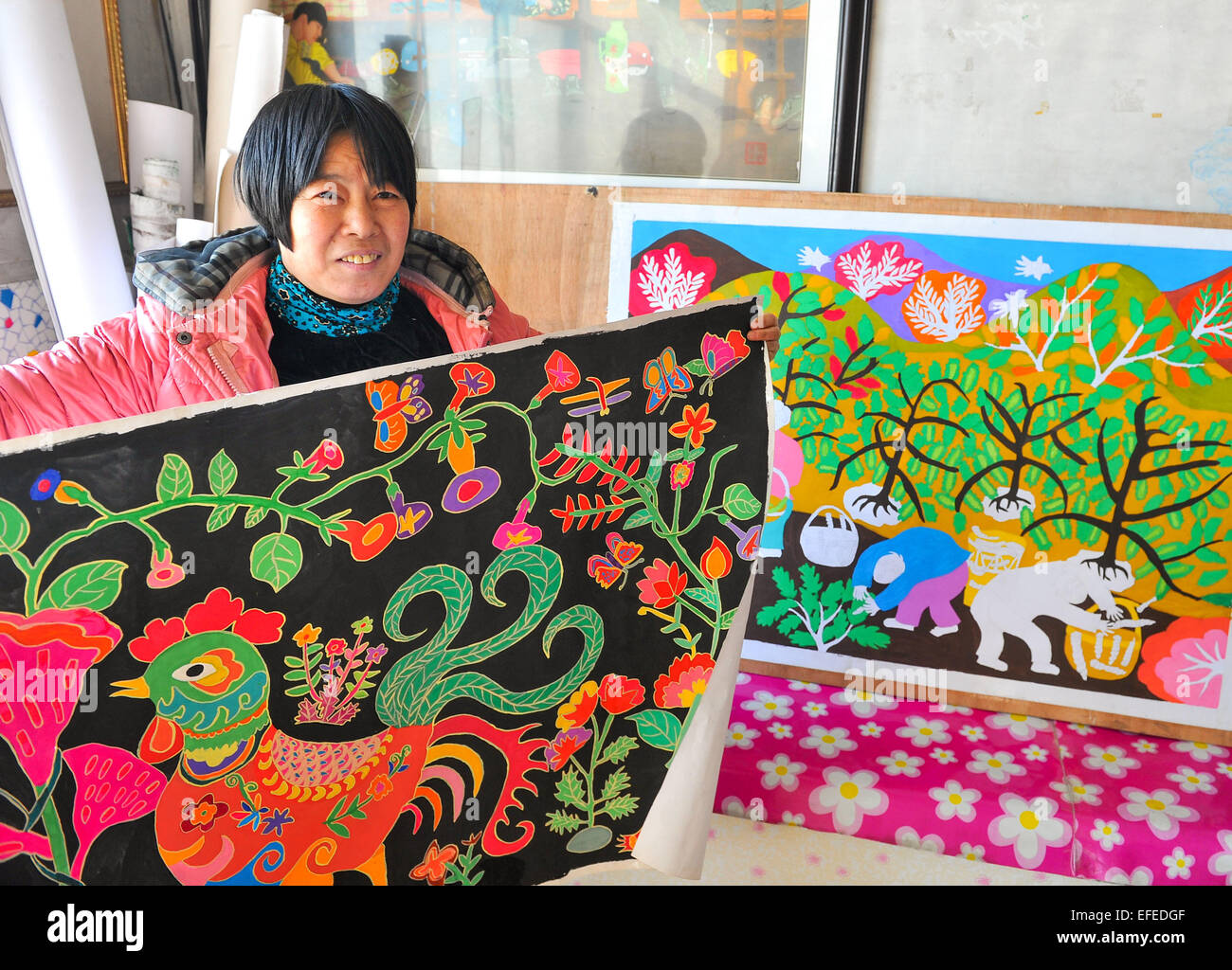 Dongfeng, China's Jilin Province. 2nd Feb, 2015. Wang Suling, a local villager, presents her country folk painting works at Wanlonghe Village in Dongfeng County, northeast China's Jilin Province, Feb. 2, 2015. The country folk painting of Dongfeng, which has the reputation as China's 'town of country folk painting', is famous for its strong local flavor in depicting life and folk-customs of northeast China's rural area. © Zhao Mengzhuo/Xinhua/Alamy Live News Stock Photo