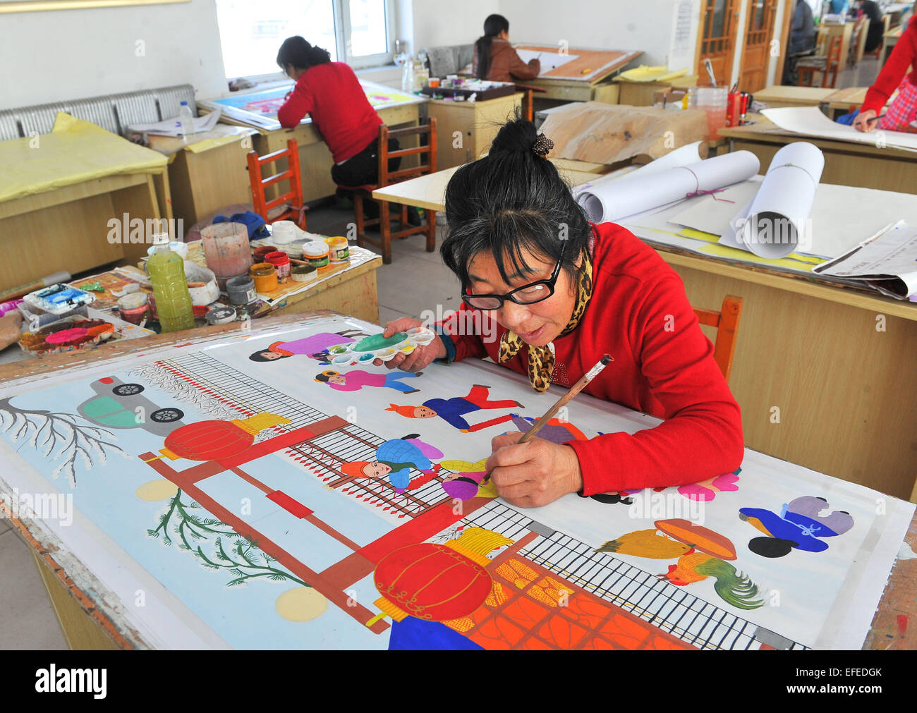 Dongfeng, China's Jilin Province. 2nd Feb, 2015. A country folk painting artisan works on a painting in Dongfeng County, northeast China's Jilin Province, Feb. 2, 2015. The country folk painting of Dongfeng, which has the reputation as China's 'town of country folk painting', is famous for its strong local flavor in depicting life and folk-customs of northeast China's rural area. © Zhao Mengzhuo/Xinhua/Alamy Live News Stock Photo