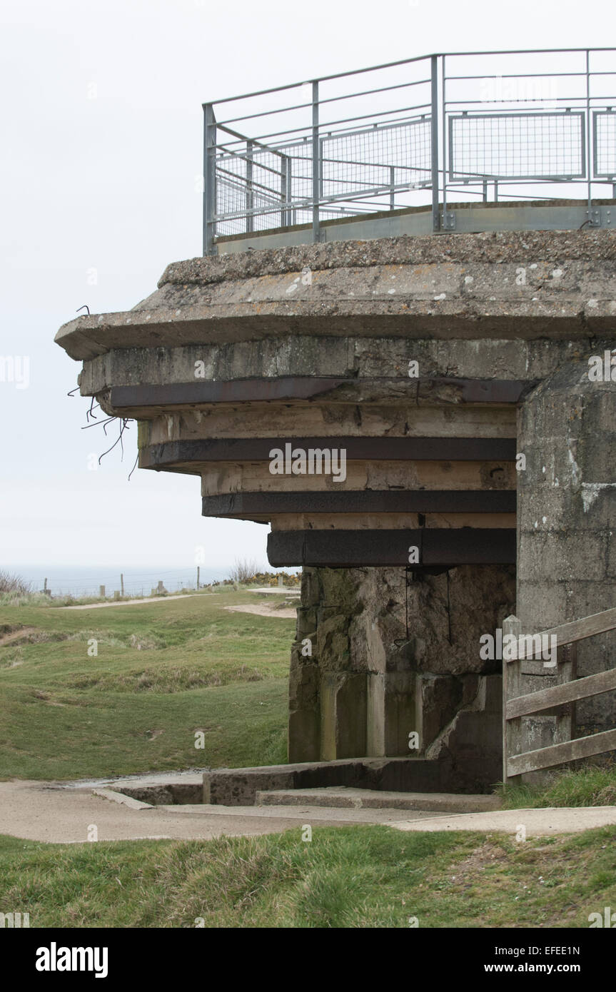 Battered German gun emplacement on the Normandy beach defenses, damaged by Allied invasion forces on D-Day Stock Photo