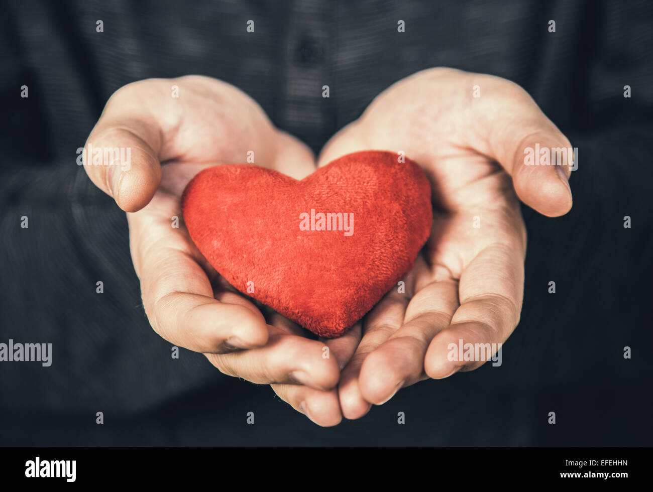 man holding red heart in her hands Stock Photo - Alamy