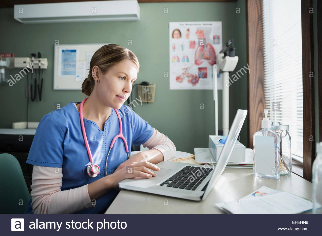 Nurse at laptop in doctors office Stock Photo Alamy