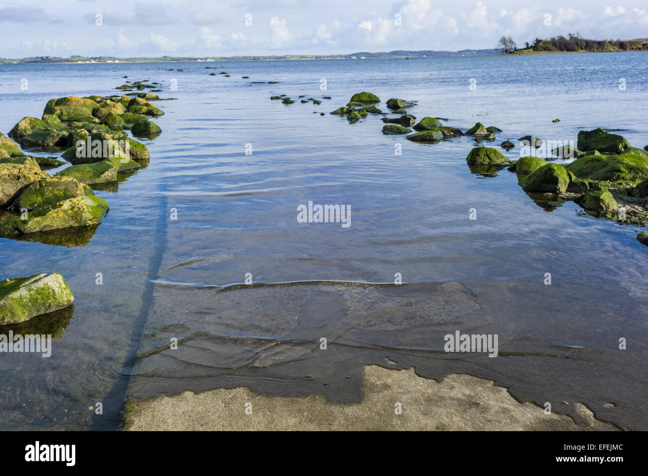 The path to Island Hill is cut off by the rising tide, the path is slowly submerged. Stock Photo