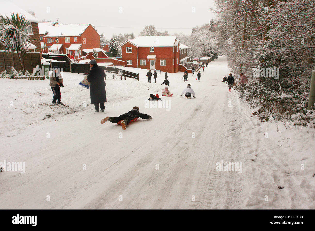 People sledging on Forest Road in Bordon, Hampshire after heavy snowfall in 2009 caused travel disruption. Stock Photo
