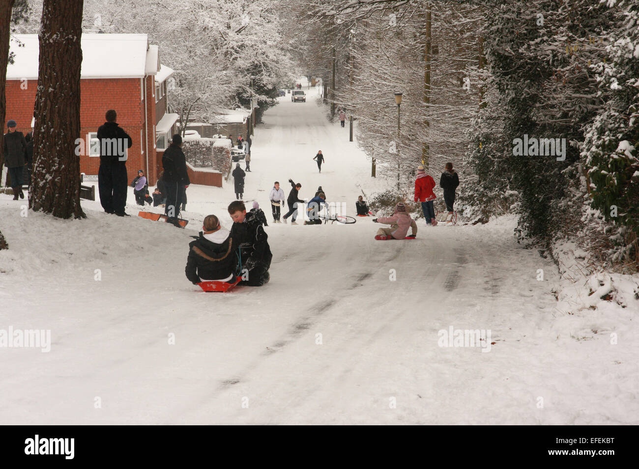 People sledging on Forest Road in Bordon, Hampshire after heavy snowfall in 2009 caused travel disruption. Stock Photo