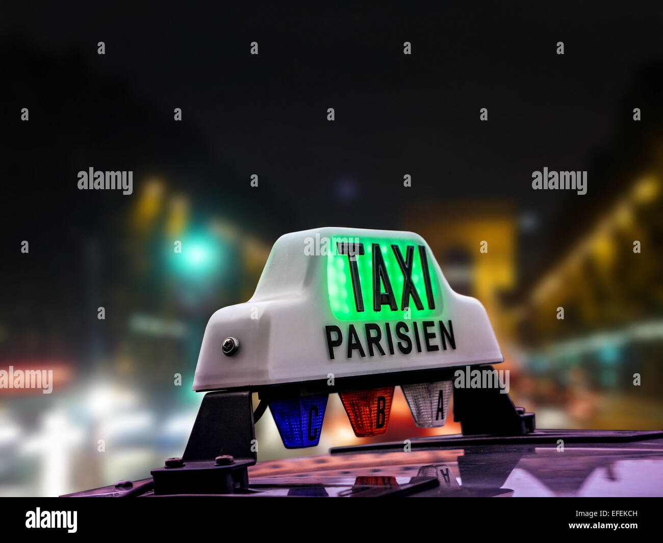 Closeup of Parisian taxi cab against the blurred Champs Elysees at night, Paris, France Stock Photo
