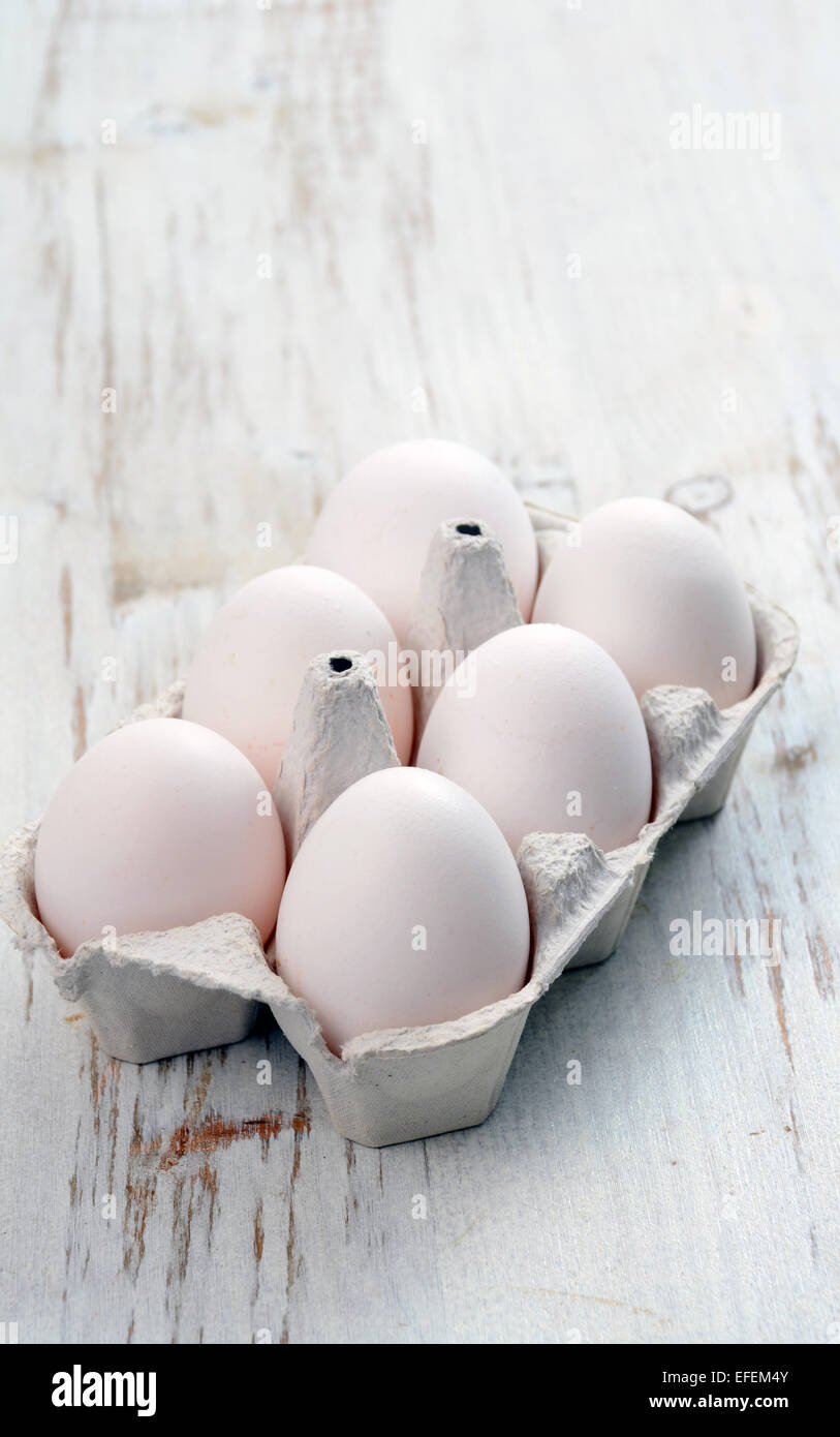 White eggs on a wooden background Stock Photo