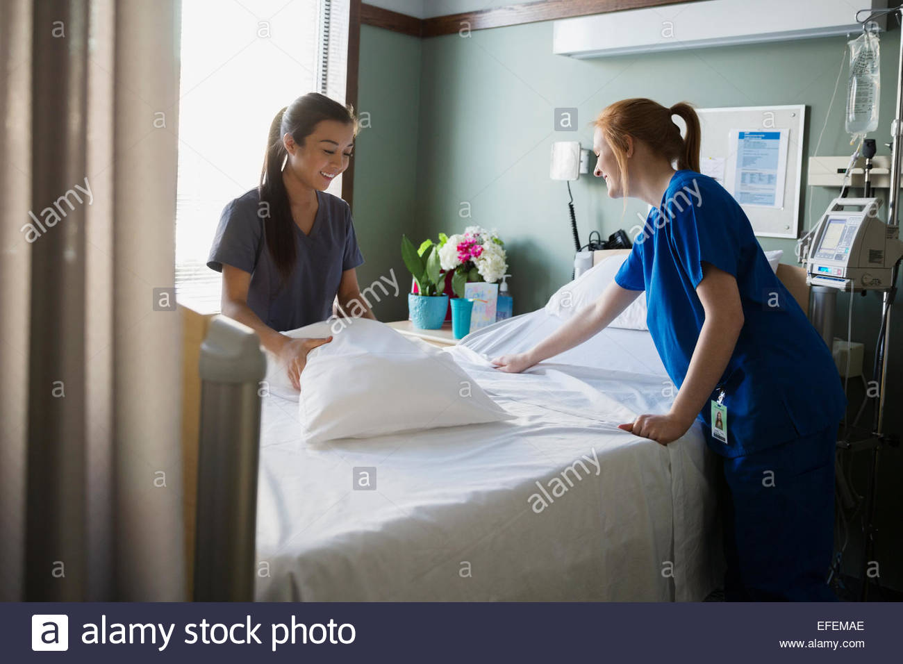 Nurses making hospital bed Stock Photo