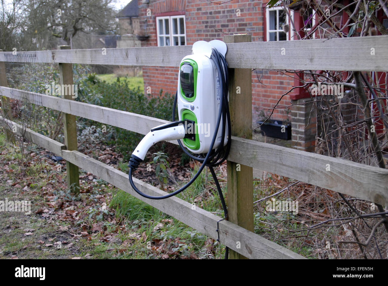 An electric car charging unit outside rural cottage Stock Photo Alamy