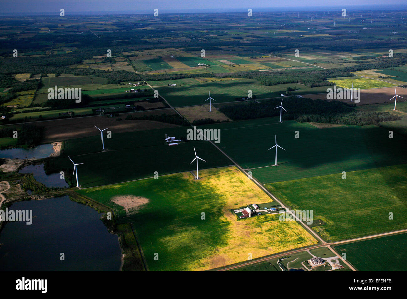 Wind turbines amongst farmland in the Saginaw Bay area. Stock Photo