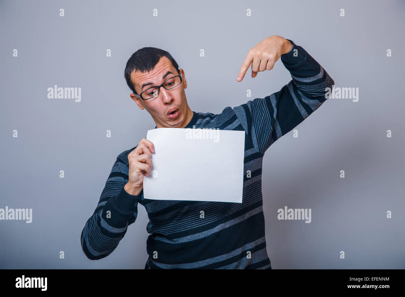 European-looking man of 30 years holding a blank sheet Stock Photo