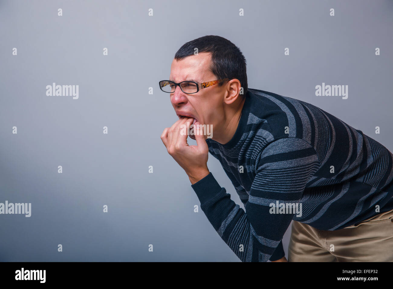 male of European appearance causes vomiting putting his fingers Stock