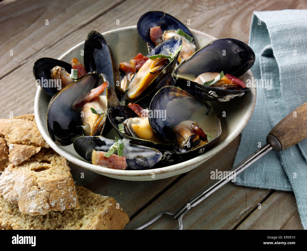 Mussels with cider and smoky bacon Stock Photo