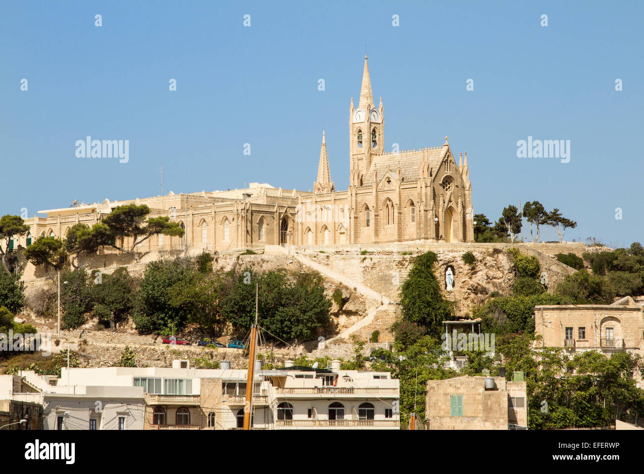 The lady of Lourdes church on the blue skyline at Mġarr Harbour Gozo Malta Stock Photo