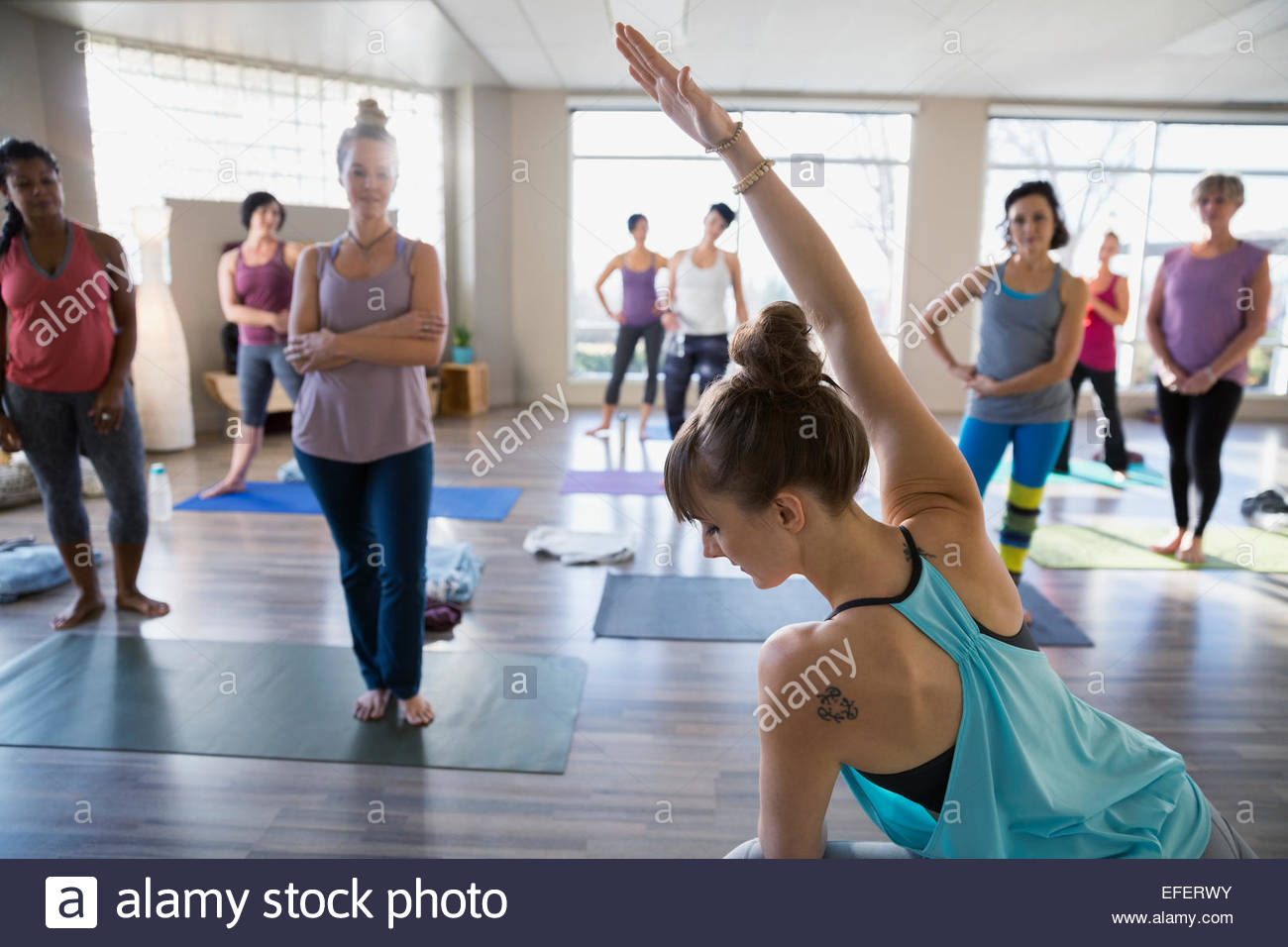 Yoga instructor demonstrating modified side angle pose Stock Photo
