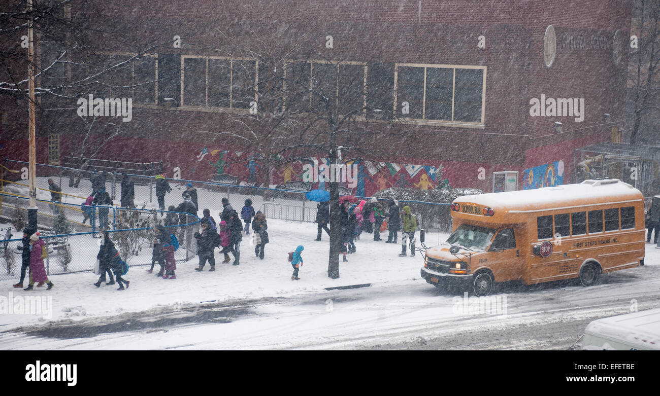 Students are discharged from Public School 33 in the Chelsea neighborhood of New York on Monday, January 26, 2015. Schools will close tomorrow, vehicles are banned after 11PM, commuter rails and buses will go to reduced service and eventually shut down as a massive blizzard approaches the Northeast which will drop up to two feet of snow in the city. (© Richard B. Levine) Stock Photo