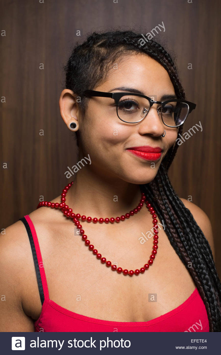 Portrait of smiling woman with braids and eyeglasses Stock Photo