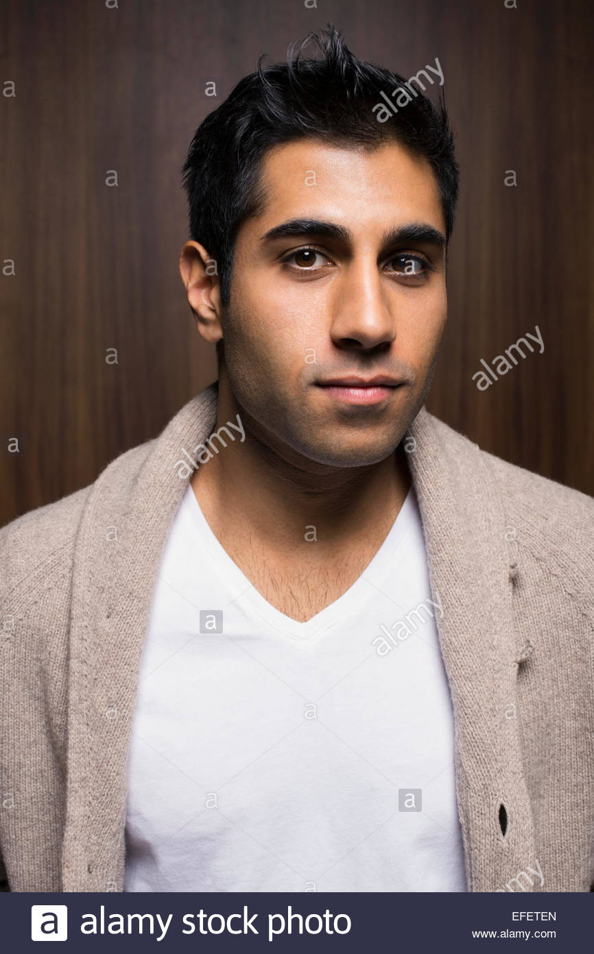 Portrait of serious man wearing cardigan sweater Stock Photo