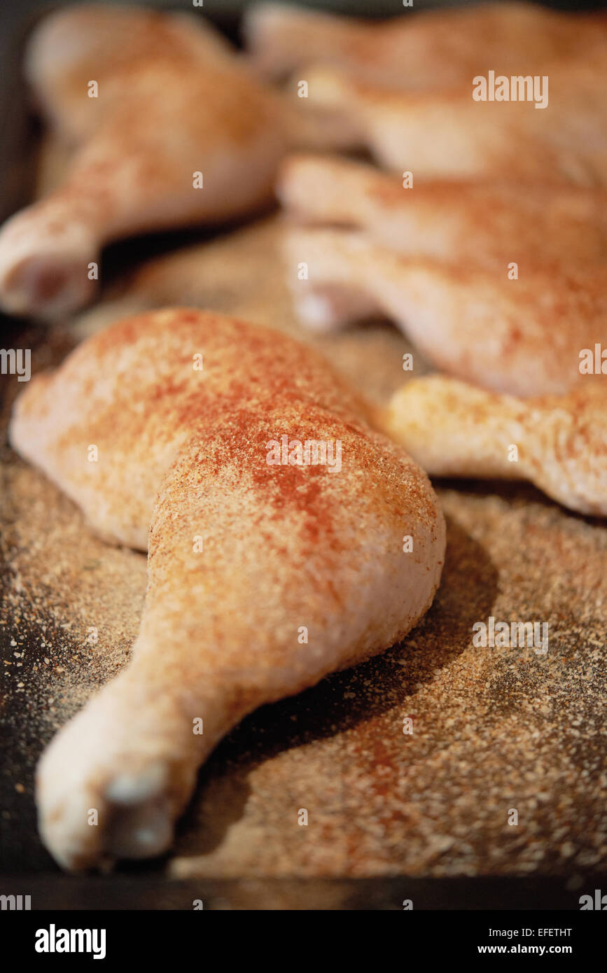 chicken Leg being prepped and seasoned for the grill Stock Photo