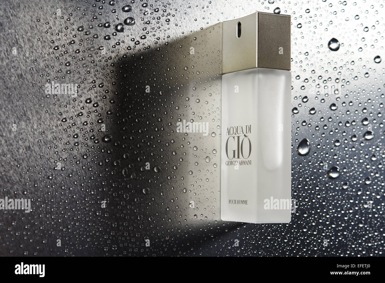 Armani Gio bottle with water droplets . Product Photography. Fragrance Stock Photo