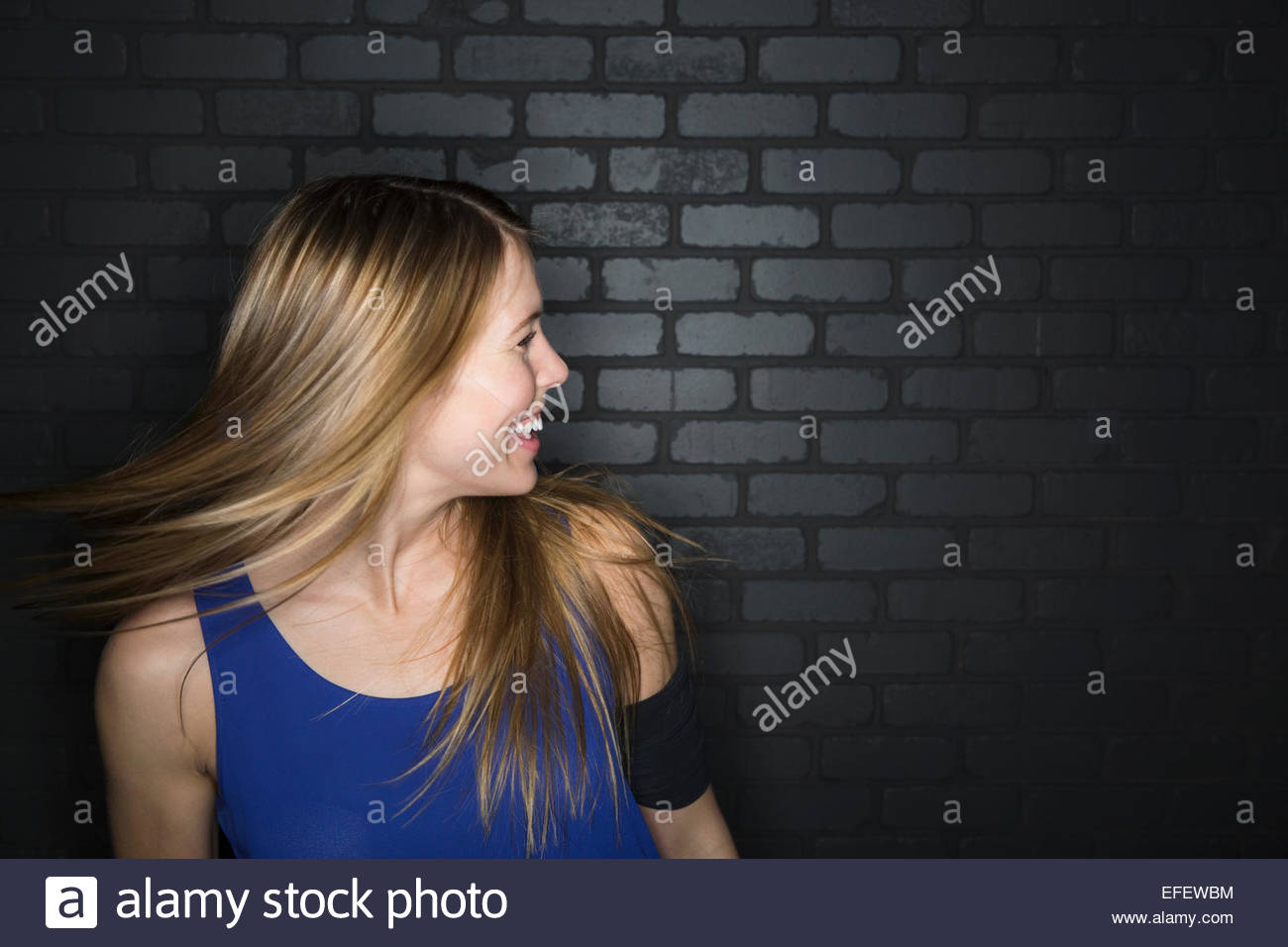 Portrait of energetic woman flipping hair Stock Photo