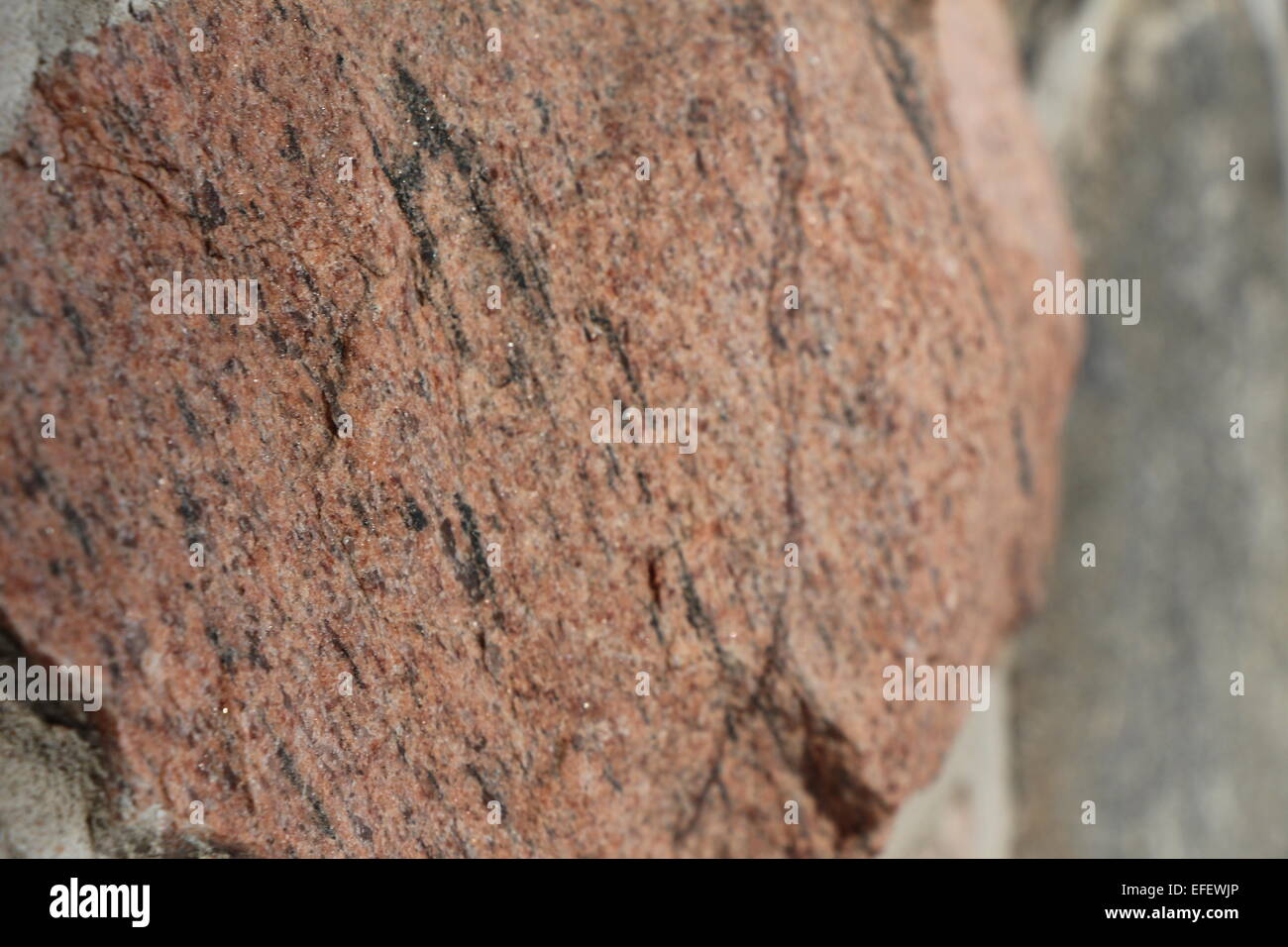 a photo of natural Canadian stone,stone,photo,granite,strong,close up,natural,red stone Stock Photo