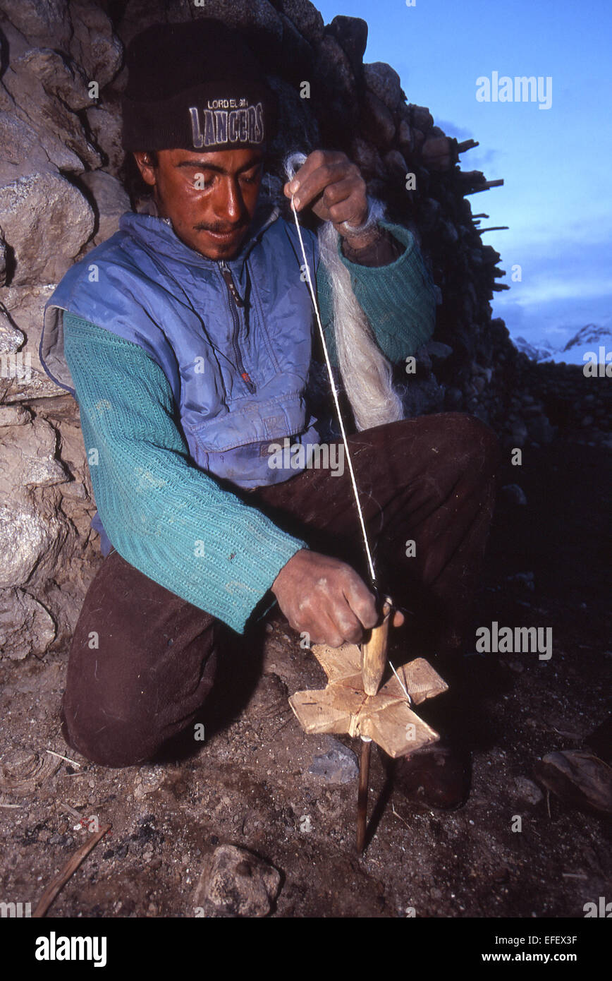 Yak herder spinning yak hair to make rope Stock Photo Alamy