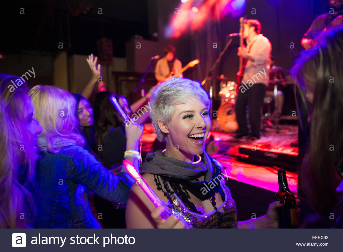 Enthusiastic women in crowd at music concert Stock Photo