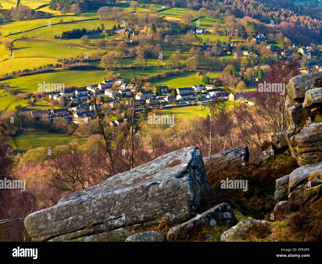 View from Froggatt Edge towards Grindleford village Peak District National Park Derbyshire England UK with rocks in foreground Stock Photo