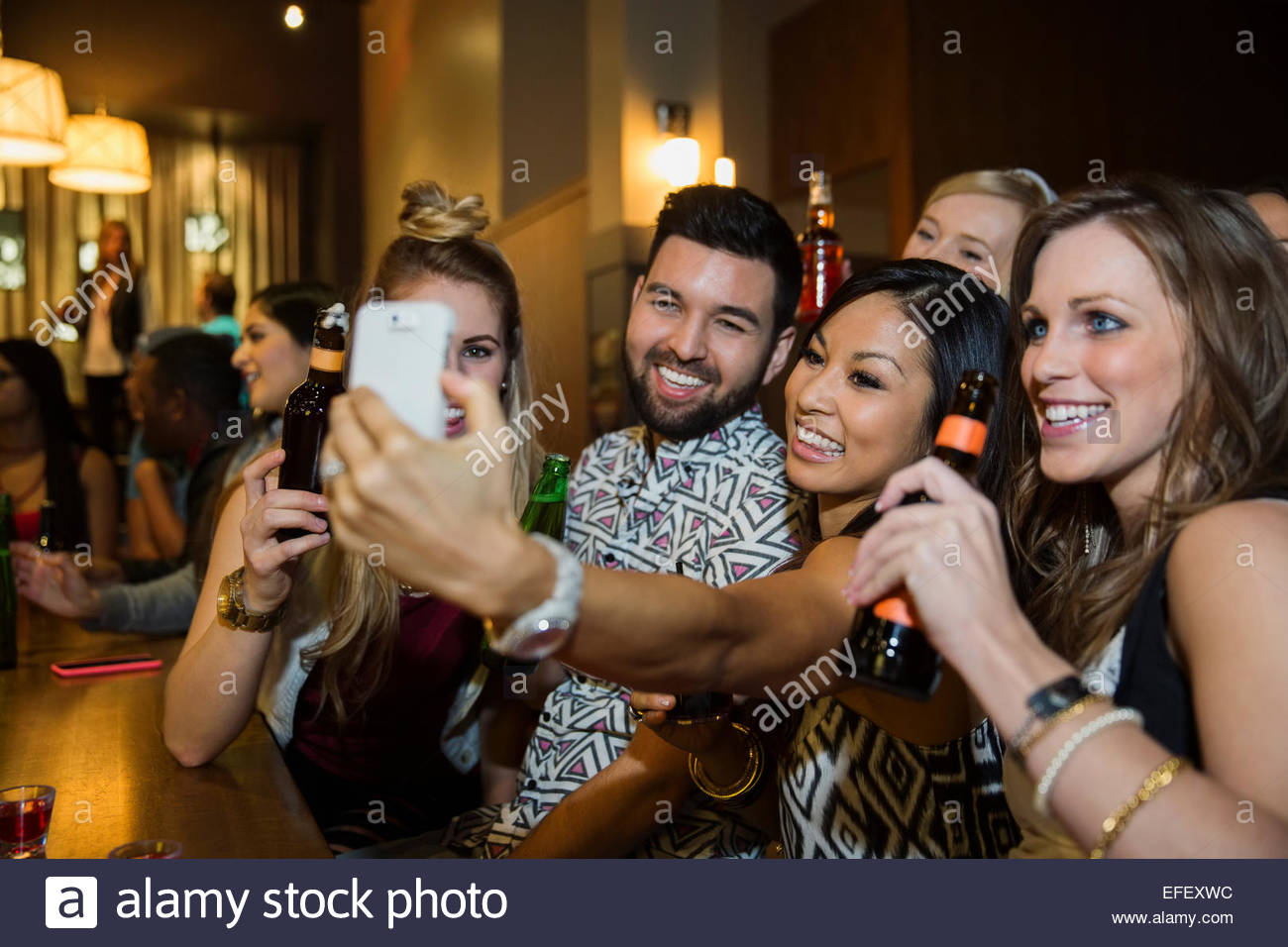 Smiling friends taking selfie at bar Stock Photo Alamy