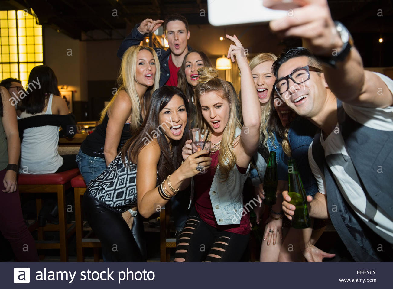 Enthusiastic friends taking selfie at bar Stock Photo Alamy